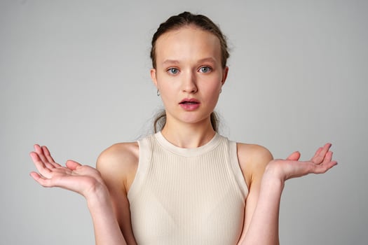 Startled Woman With Surprised Expression on gray background photo