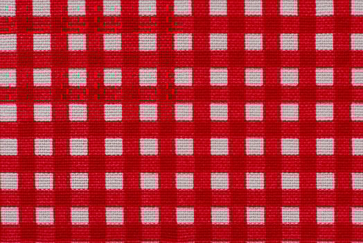 Checkered fabric white with red as background macro photo. photo