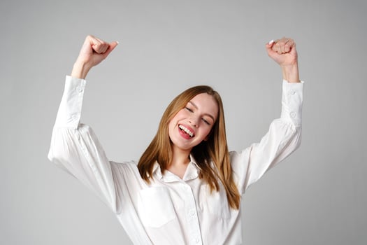 Jubilant Young Woman Celebrating a Victory With a Raised Fist in Studio photo