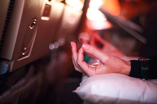 Person in airplane with aerophobia scared of flying doing yoga for relax photo
