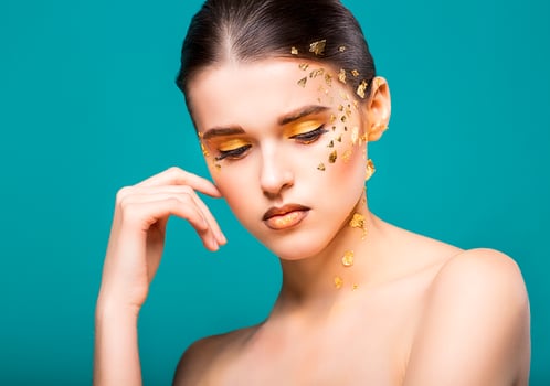 a beautiful young woman with bright golden makeup photo