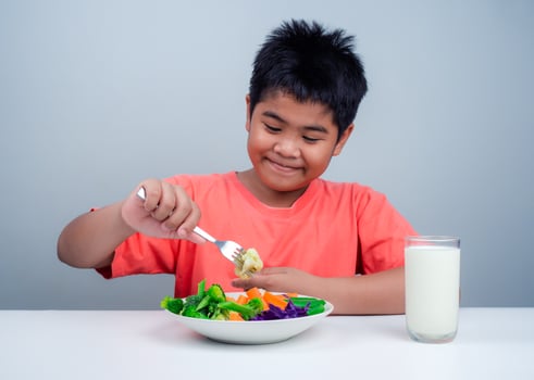 Children like to eat vegetables, Little cute boy eat healthy vegetables, Nutrition healthy eating habits for kids concept, Mixed color vegetables. photo