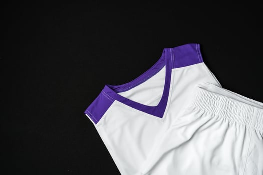 White and Purple Athletic Tank Top Laid Flat on Black Background photo