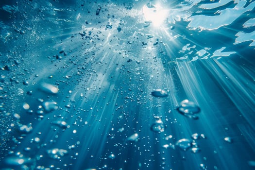 Bubbles rising beneath shimmering water surface illuminated by sunlight in a serene underwater scene photo