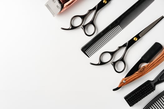 Set of barber tools for haircut on gray background flat lay photo
