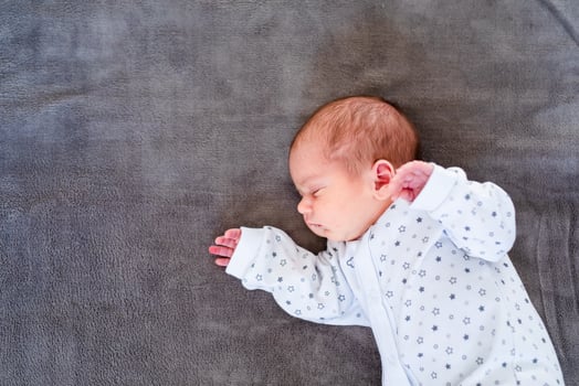 Close-up portrait of adorable baby boy sleeping in bed, 1 year old baby concept photo
