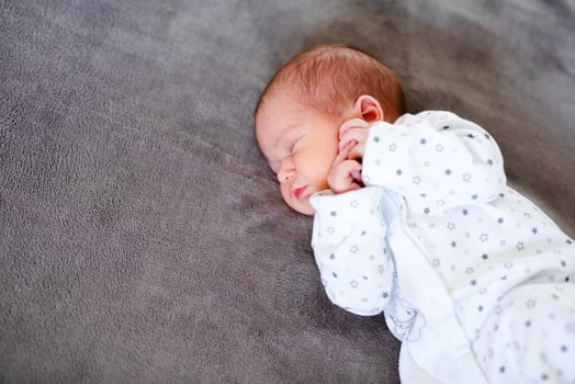 Baby boy sleeping first days of life. Cute little newborn child sleeping peacefully photo