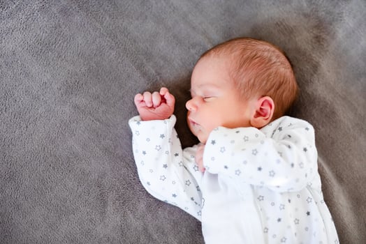 Baby boy sleeping first days of life. Cute little newborn child sleeping peacefully photo