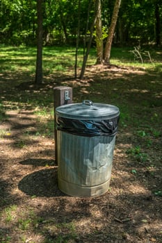 Garbage can with lid outdoors photo