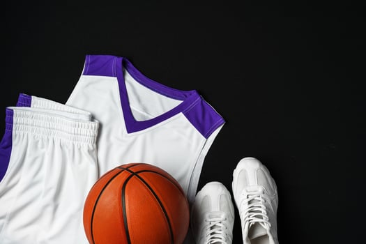 Basketball Outfit and Accessories Laid Out on Dark Background photo