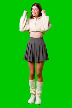 Woman in Skirt and Sweater Posing for Camera photo