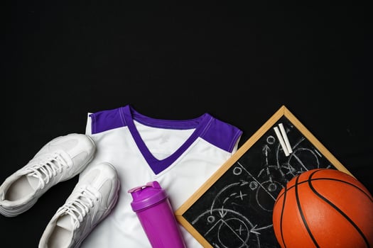 Basketball Gear Including Sneakers, Ball, and Play Strategy Board on Black Background photo