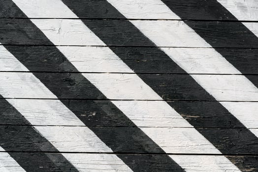Boards are painted with black and white paint diagonally. Abstract background. photo