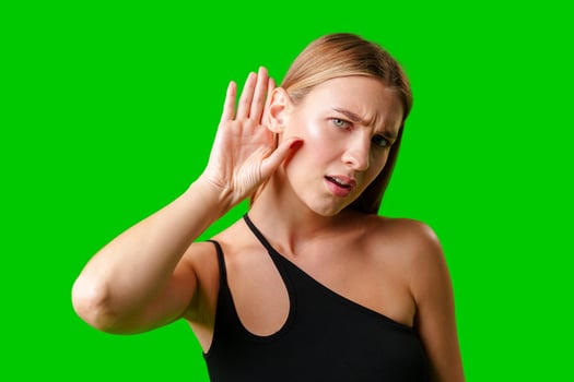 Young Woman in Black Top Holding Hand to Ear photo