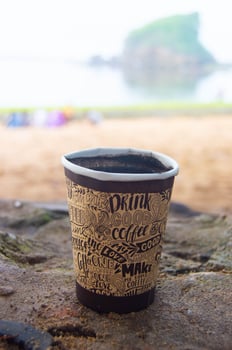 close up coffee cup with view on the beach photo