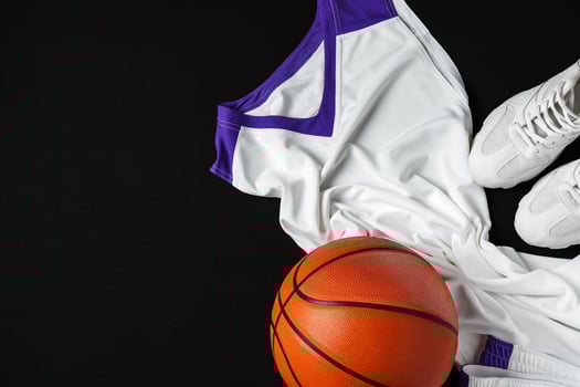 Basketball Outfit and Accessories Laid Out on Dark Background photo