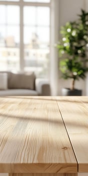 Bright and airy living room with wooden table and green plant in sunlight photo