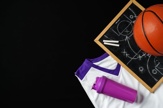Basketball Strategy Planning With Chalkboard, Ball, and Jersey on Dark Background photo