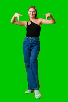 Young Woman Pointing at Something against green background photo