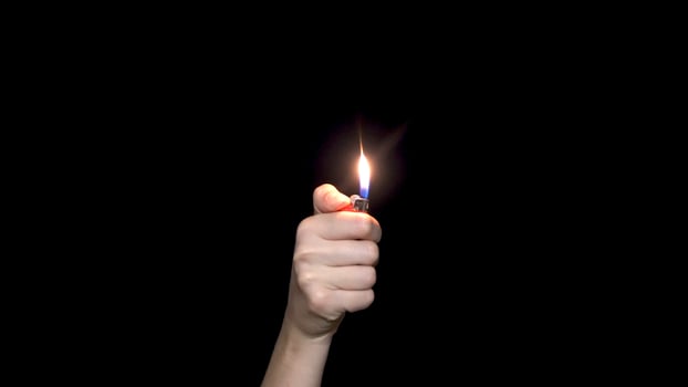 Male hand holding a red lighter, isolated on white background. Hand holding burning gas lighter. photo