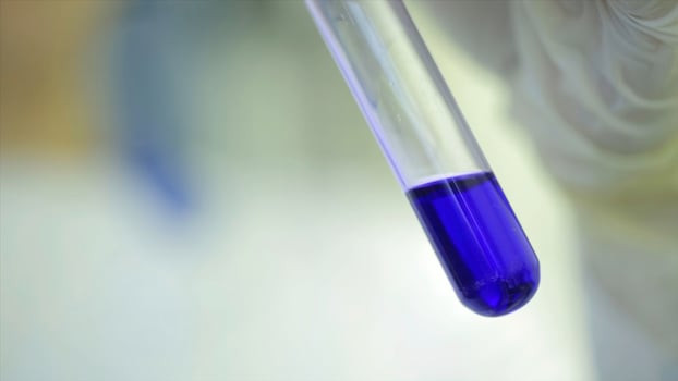Test tubes closeup. Medical equipment. Close-up footage of a scientist using a micro pipette in a laboratory. Laboratory technician injecting liquid into a microtiter plate. Test tubes. Small depth of photo