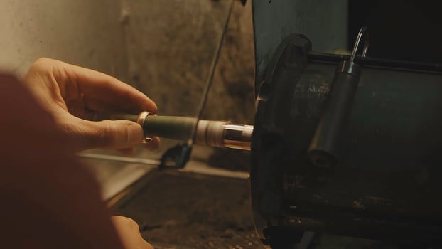 Production of rings. Jeweler working with wax model ring in his workshop. Craft jewelery making. Detail shot with low depth of field. Jeweler making handmade jewelry on vintage workbench. Craft of photo