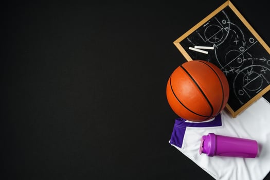 Basketball Strategy Planning With Chalkboard, Ball, and Jersey on Dark Background photo