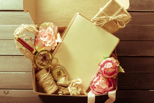 flowers and a notebook on wooden background photo