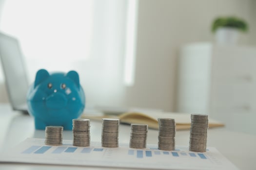 Saving money wealth concept, asian young business woman hand write management budget for saving cost, cash finance planning to spend enough money on her income for save money, payment tax, investing. photo