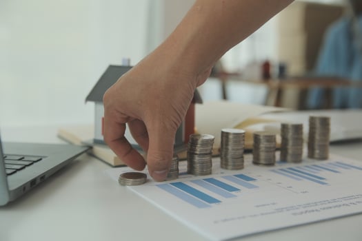 Saving money wealth concept, asian young business woman hand write management budget for saving cost, cash finance planning to spend enough money on her income for save money, payment tax, investing. photo