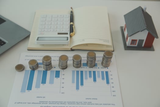 Saving money wealth concept, asian young business woman hand write management budget for saving cost, cash finance planning to spend enough money on her income for save money, payment tax, investing. photo