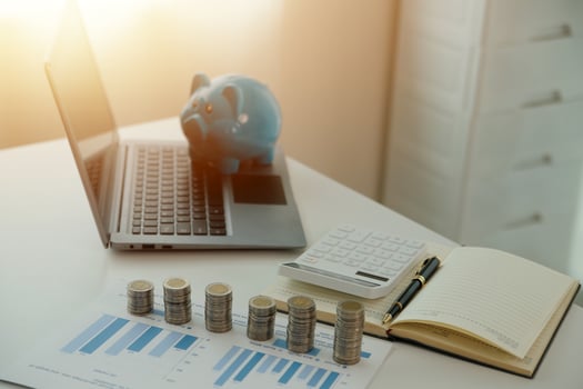 Saving money wealth concept, asian young business woman hand write management budget for saving cost, cash finance planning to spend enough money on her income for save money, payment tax, investing. photo