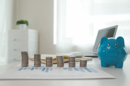Saving money wealth concept, asian young business woman hand write management budget for saving cost, cash finance planning to spend enough money on her income for save money, payment tax, investing. photo