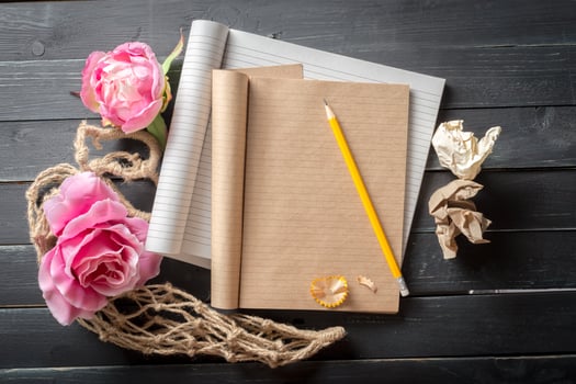 flowers and a notebook on wooden background photo