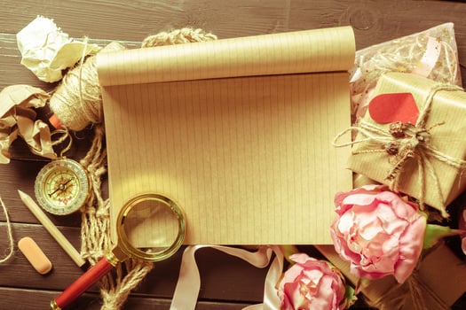 flowers and a notebook on wooden background photo