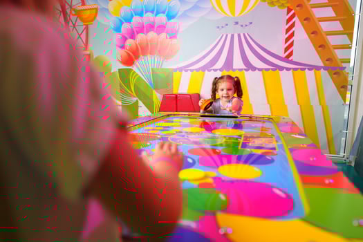 Young Girl Engaging in Colorful Board Game Fun at a Vibrant Playroom photo