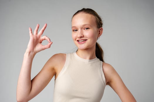 Young Girl Giving Thumbs Up Sign in studio photo