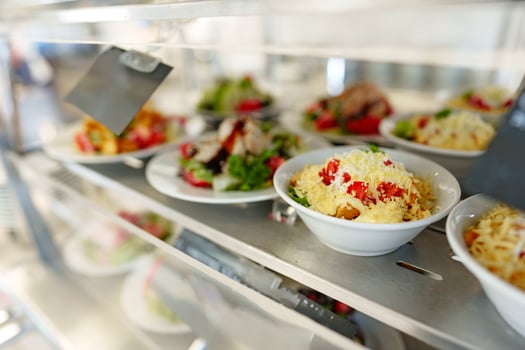 Freshly Prepared Salads on Display in a Cafeteria During Lunchtime photo