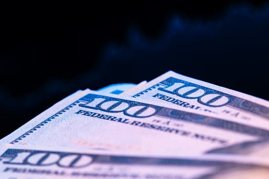 Dollars in front of a monitor with a price chart. Forex and trading. photo