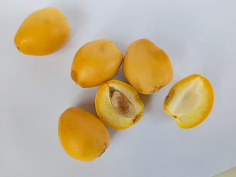 Kurma Muda or Raw Golden Young Dates isolated on white background photo