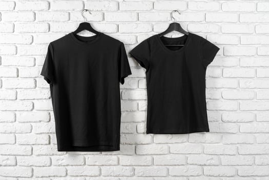 Black t-shirt hanging on a hanger against brick wall photo
