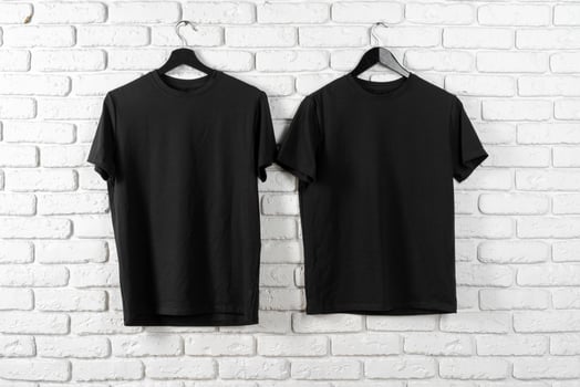 Black t-shirt hanging on a hanger against brick wall photo