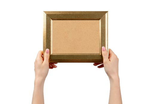 Female hands holding photo frame isolated on white