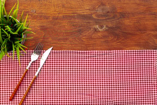 Red checkered napkin or tablecloth on wooden table photo