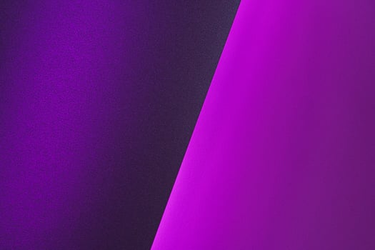 Blank paper sheets rolled in a neon purple lighting photo