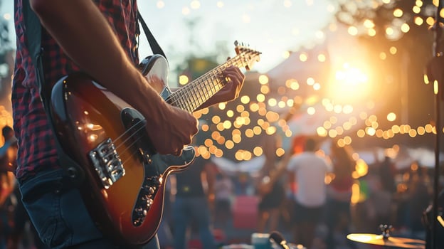 Musicians perform at Open Air Music Festival, man playing guitar with friends live music event photo