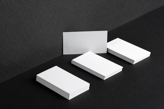 Stacked white businesscards for branding identity on black background photo
