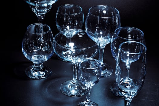 Empty glasses for drinks on dark background photo