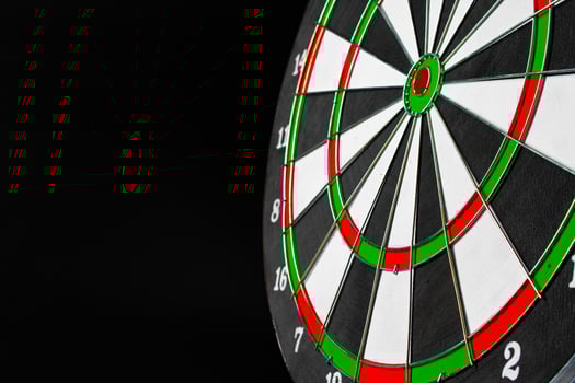 Dartboard on black dark background close up photo