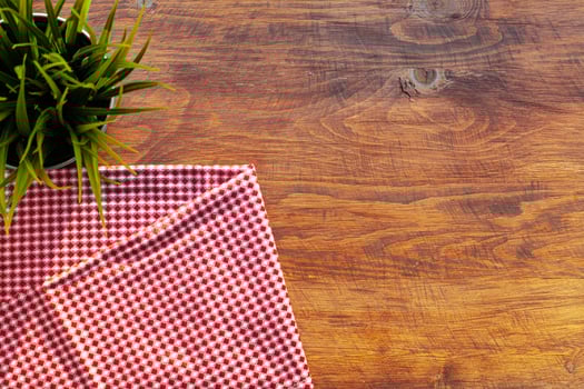 Red checkered napkin or tablecloth on wooden table photo